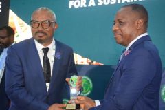 Amb. Gabriel Aduda, Permanent Secretary, Ministry of Petroleum Resources presenting the recognition award to the MD, Engr OBI Uzu after his panel session at the NIES 2023.